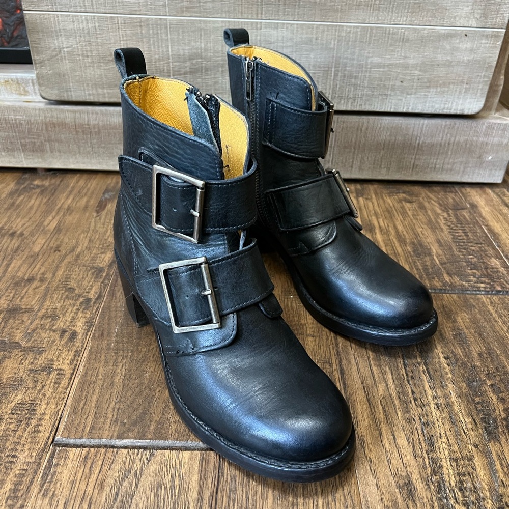 Frye buckle black leather boots.